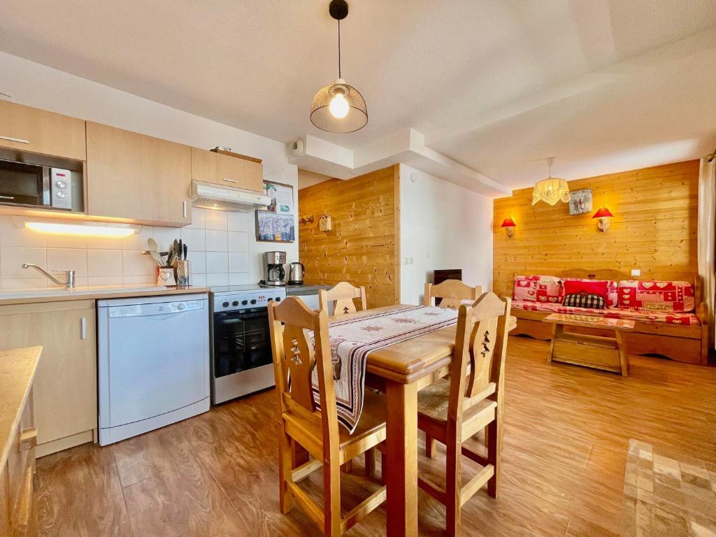 a kitchen and dining room with a table and chairs at Appartement Flumet, 2 pièces, 4 personnes - FR-1-505-202 in Flumet