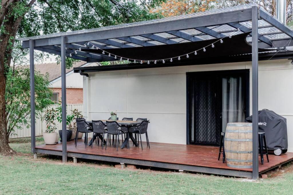 a patio with a table and chairs on a deck at Live in the Heart of Mudgee at Fairbairn Cottage in Mudgee