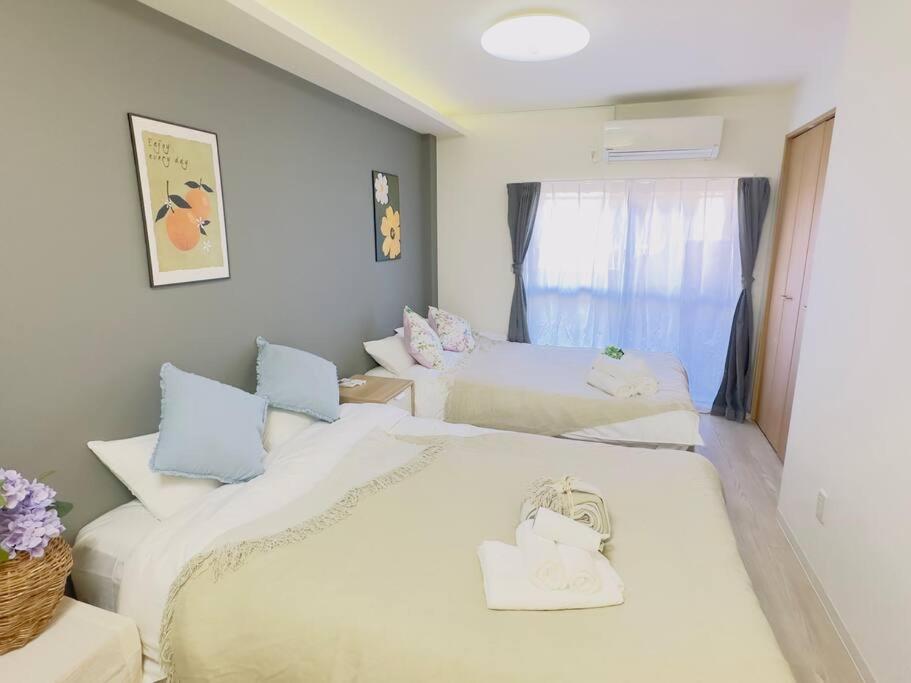 a room with two beds and a window at 100m from nearest bus stop/8 mins to Ikebukuro sta in Tokyo