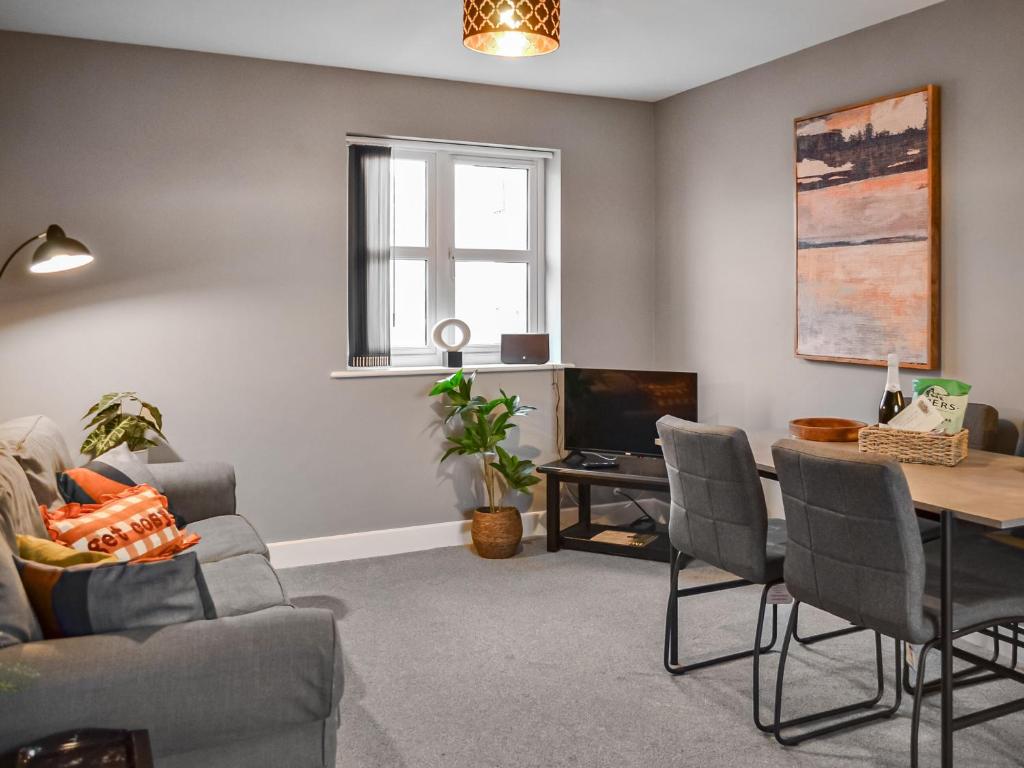 a living room with a couch and a table at The Gainsborough Mews in Gainsborough