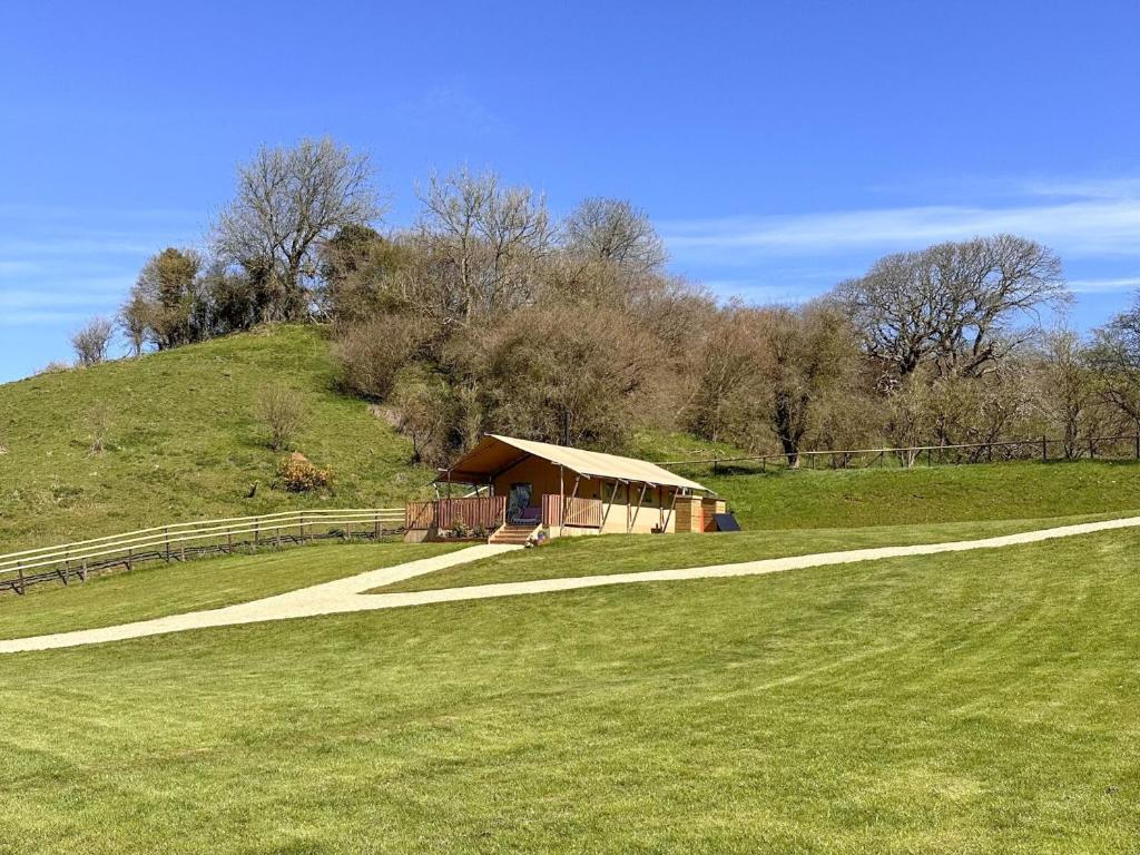 a small tent in a field with a hill at Horscombe Lodge - Ukc6261 in Castle Cary