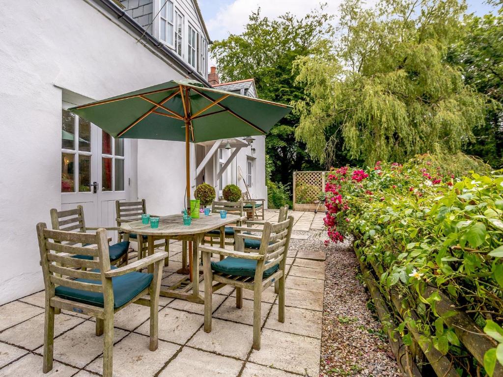 a patio with a table and chairs and an umbrella at 3 Bed in Bucks Mills OLDSB in Bucks Mills