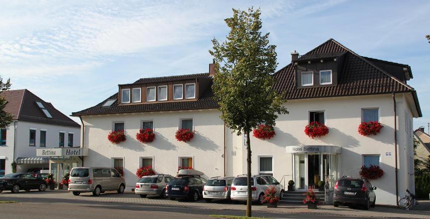 a large white building with cars parked in front of it at Hotel Bettina garni in Günzburg