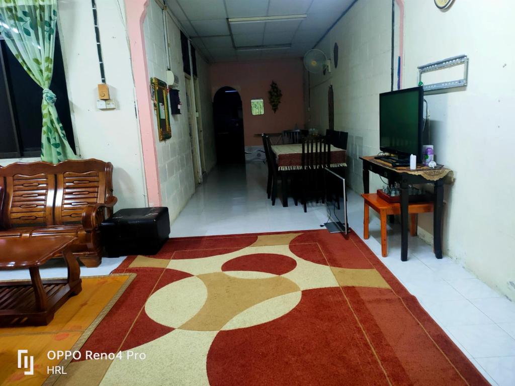 a hallway with a room with a rug on the floor at HrL Homestay Kangar in Kangar