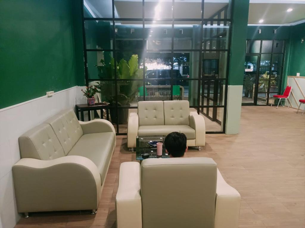 a person sitting on a couch in a waiting room at Quanza Hotel in Banda Aceh