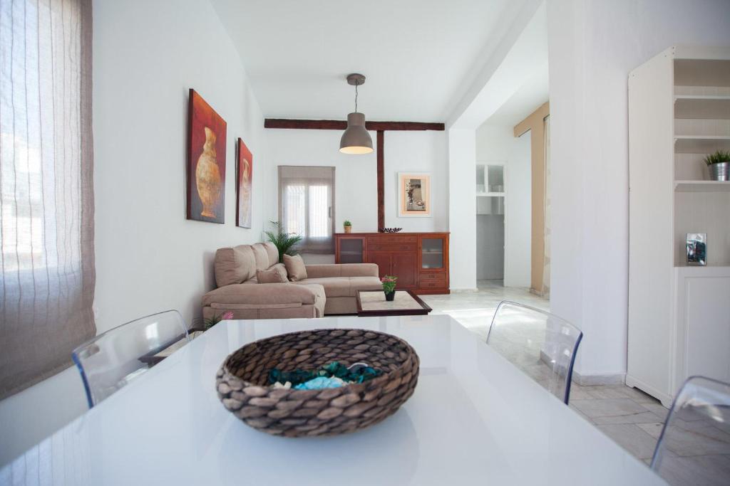 a living room with a white table and chairs at Apartamentos Catedral in Málaga