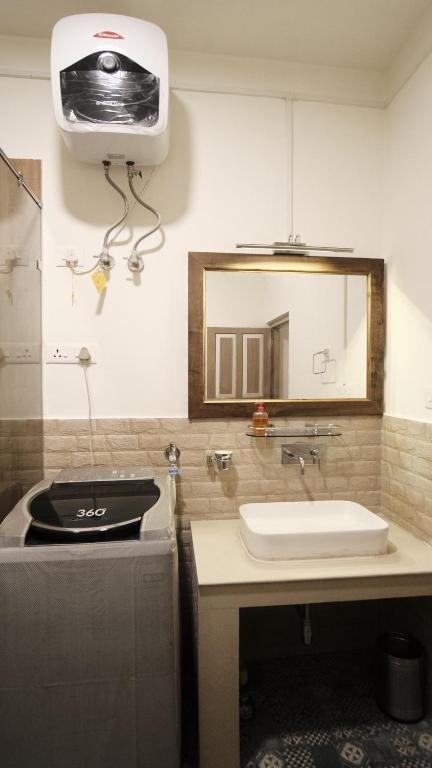 a bathroom with a sink and a mirror at Pink Rose Homestay in Gangtok