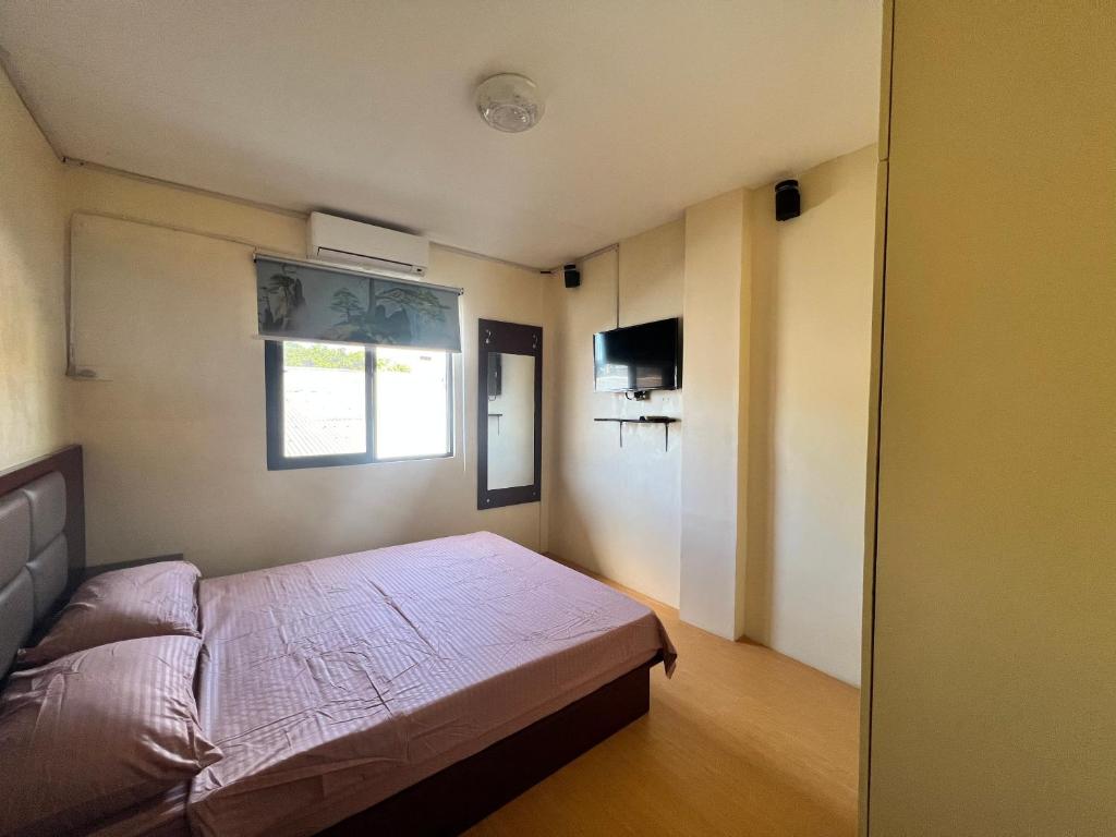 Postel nebo postele na pokoji v ubytování APARTELLE BORACAY