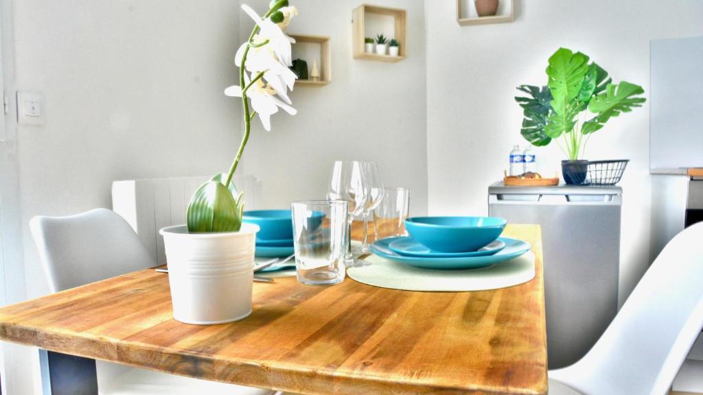 a dining room table with a plant on it at Take your time in Cluses