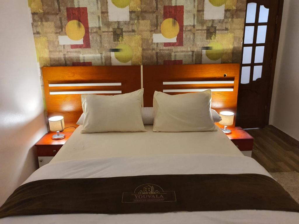 מיטה או מיטות בחדר ב-YOUVALA Serviced Apartments City Star