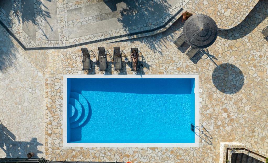 an overhead view of a swimming pool on the ground at Electra Villa & Pool Studios in Gaios