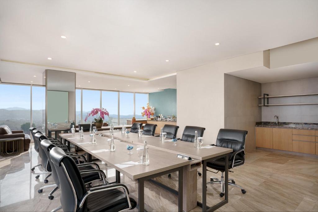 a large conference room with a long table and chairs at Golden Tulip Springhill Lampung in Bandar Lampung