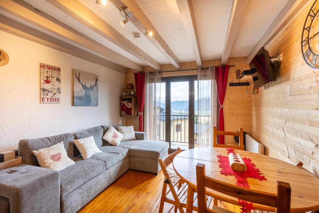 un salon avec un canapé et une table dans l'établissement La Cordée des Angles - Studio mezzanine, aux Angles