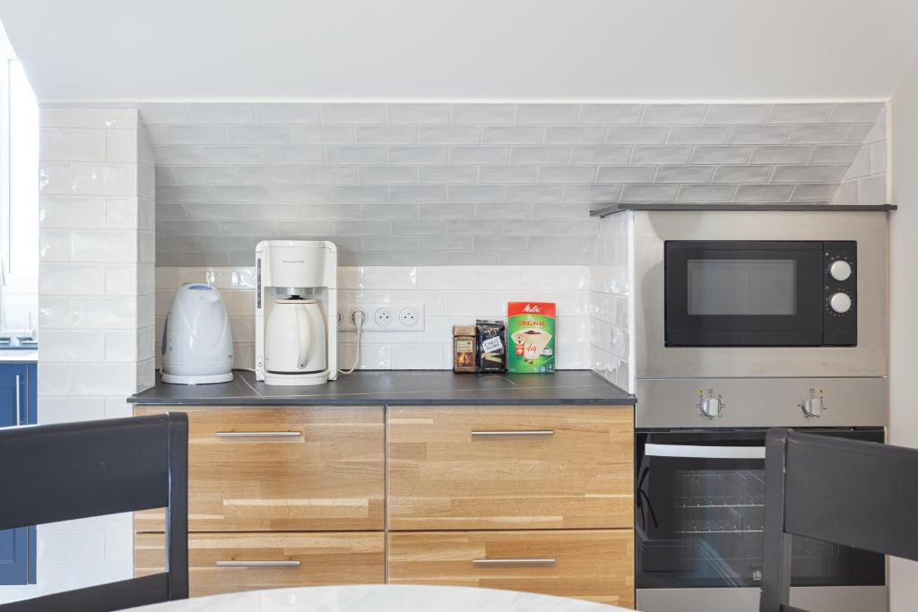 Kuchyň nebo kuchyňský kout v ubytování Les appartements de Chantilly - gare