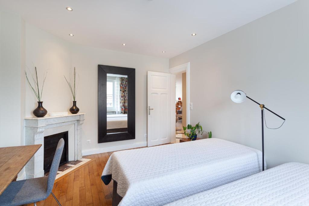 Postel nebo postele na pokoji v ubytování Les appartements de Chantilly - gare