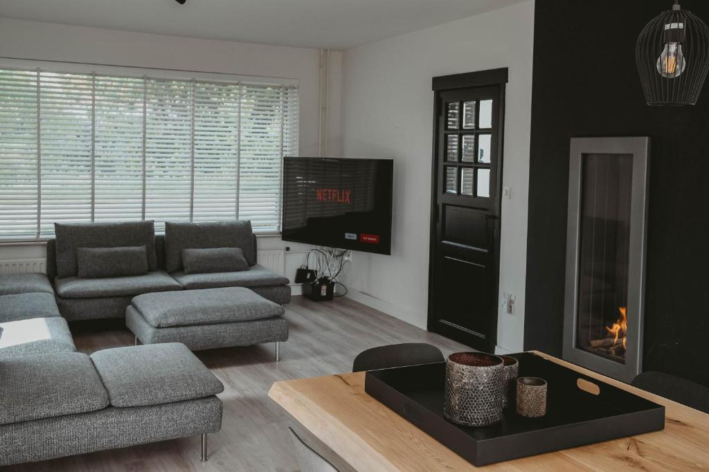 a living room with a couch and a fireplace at Villa Bandi - Group & Family House in Lanaken