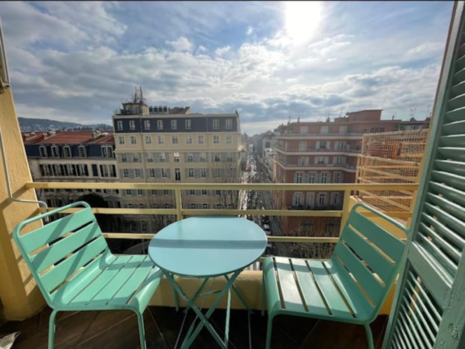 a table and chairs on a balcony with a view at Happy Home in Nice
