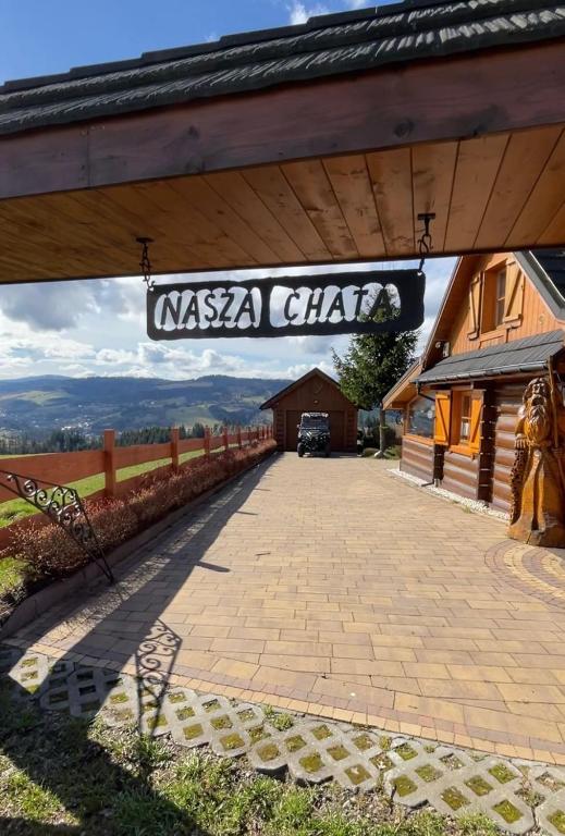 a sign for a nassascha club on a building at Nasza Chata in Jaworzynka