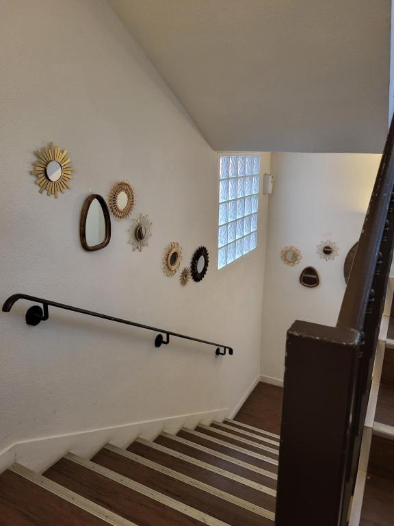 a staircase in a house with a mirror on the wall at Logis Hotel Restaurant la Ferme in Avignon