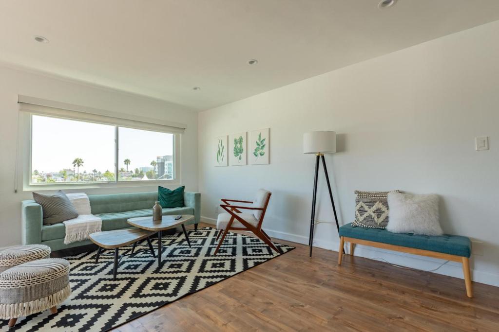 a living room with a green couch and a rug at Long Beach 1br nr aquarium groceries bars LAX-1156 in Long Beach