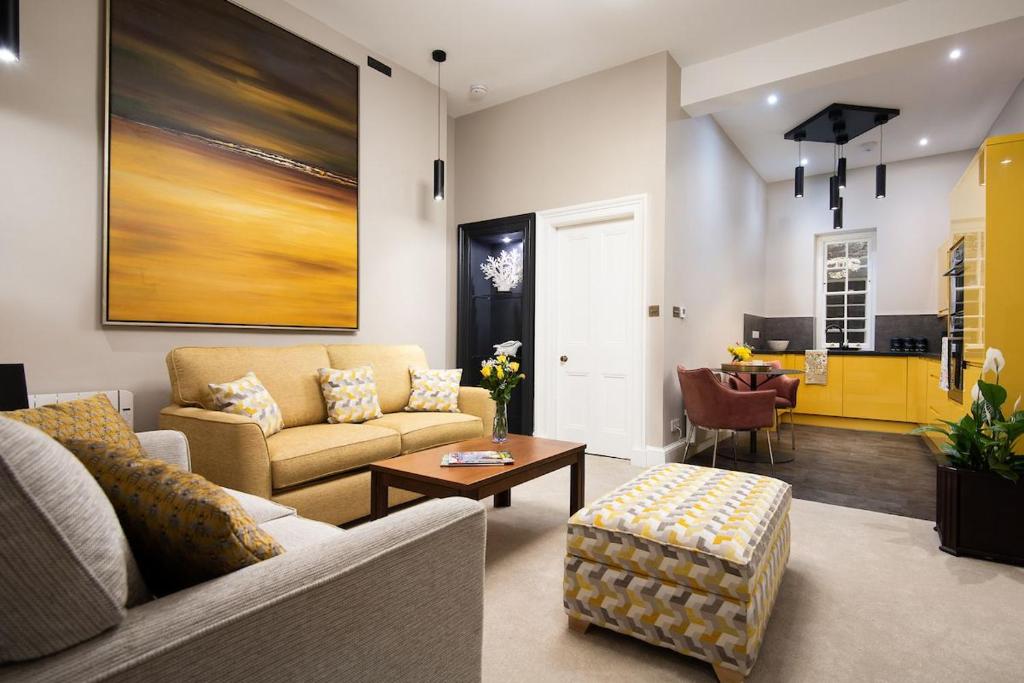 a living room with a couch and a table at The Scott Apartment in Kelso