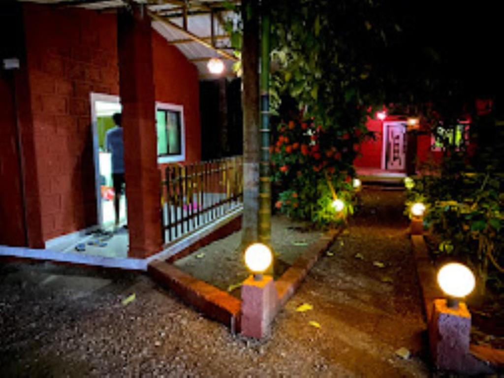 two lights on a sidewalk in front of a building at Sai Sadan Residency,Diveagar in Diveagar