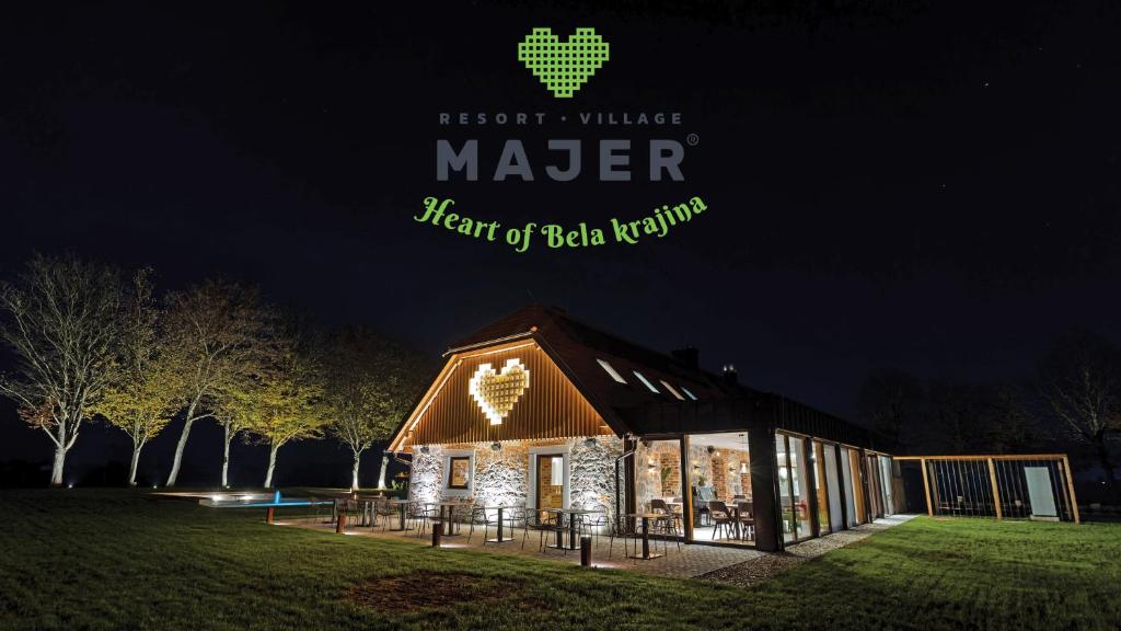 a barn lit up at night with the words heart of beta network at Resort Village Majer in Gradac
