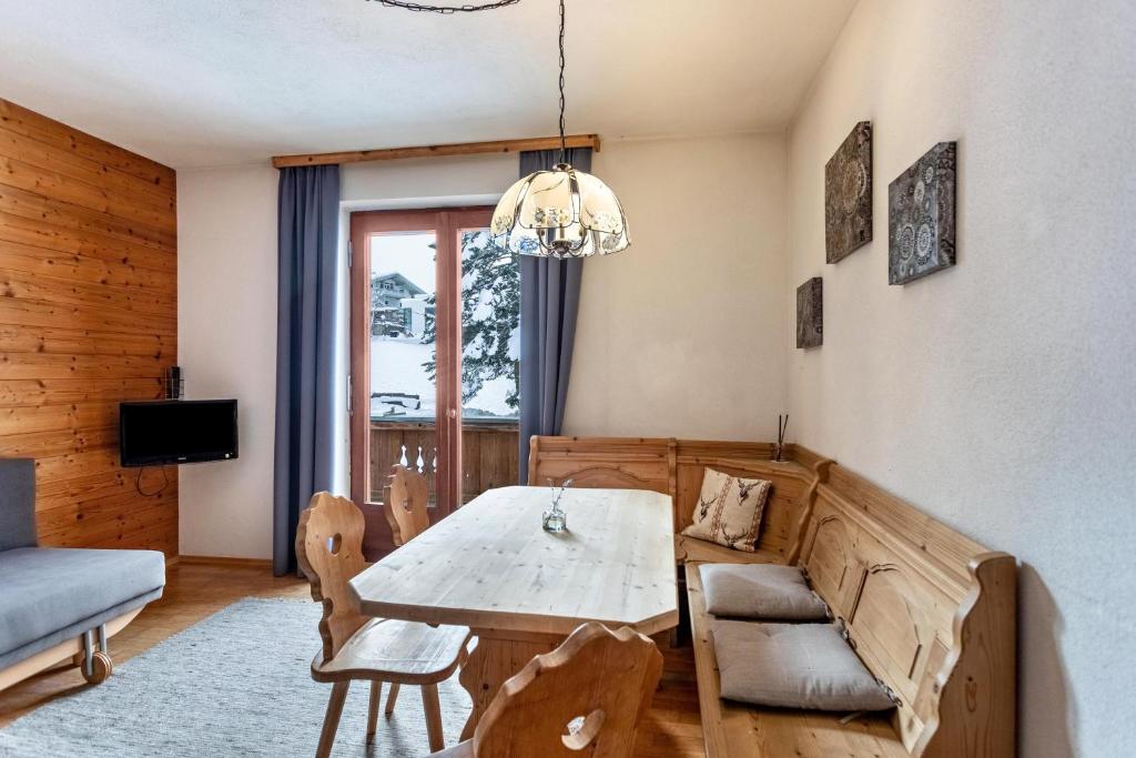 a living room with a table and chairs and a couch at Schwüwong - Apartment 02 in Kelchsau