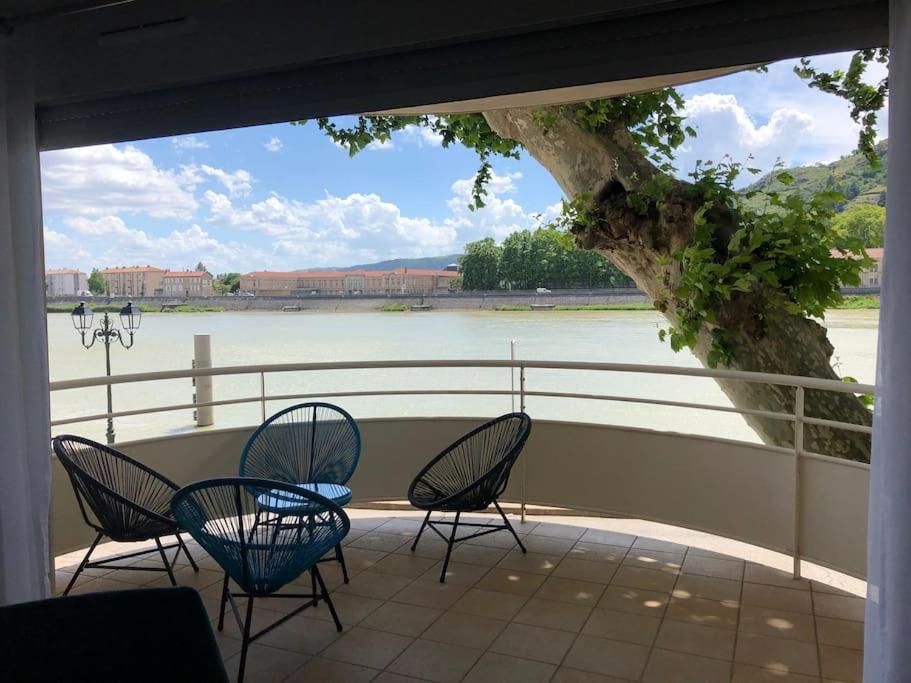 un patio con sillas y vistas al río en Blue**** Vue exceptionnelle sur le Rhône, en Tain-lʼHermitage