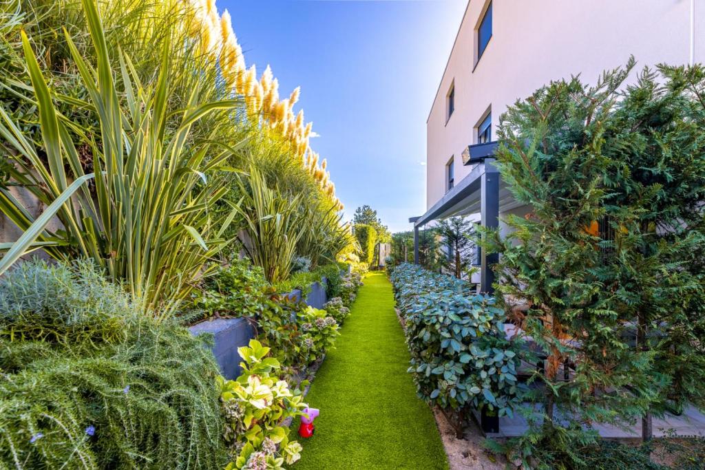 a garden with plants and a building at Villa Valis in Baška