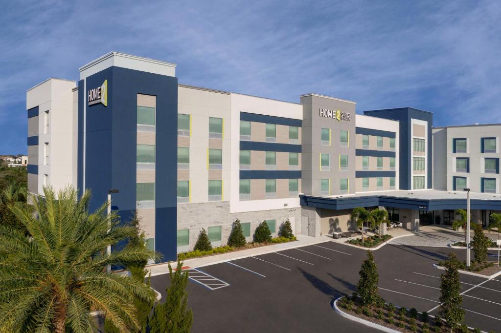 a rendering of a hotel with a parking lot at Home2 Suites Orlando Southeast Nona in Orlando