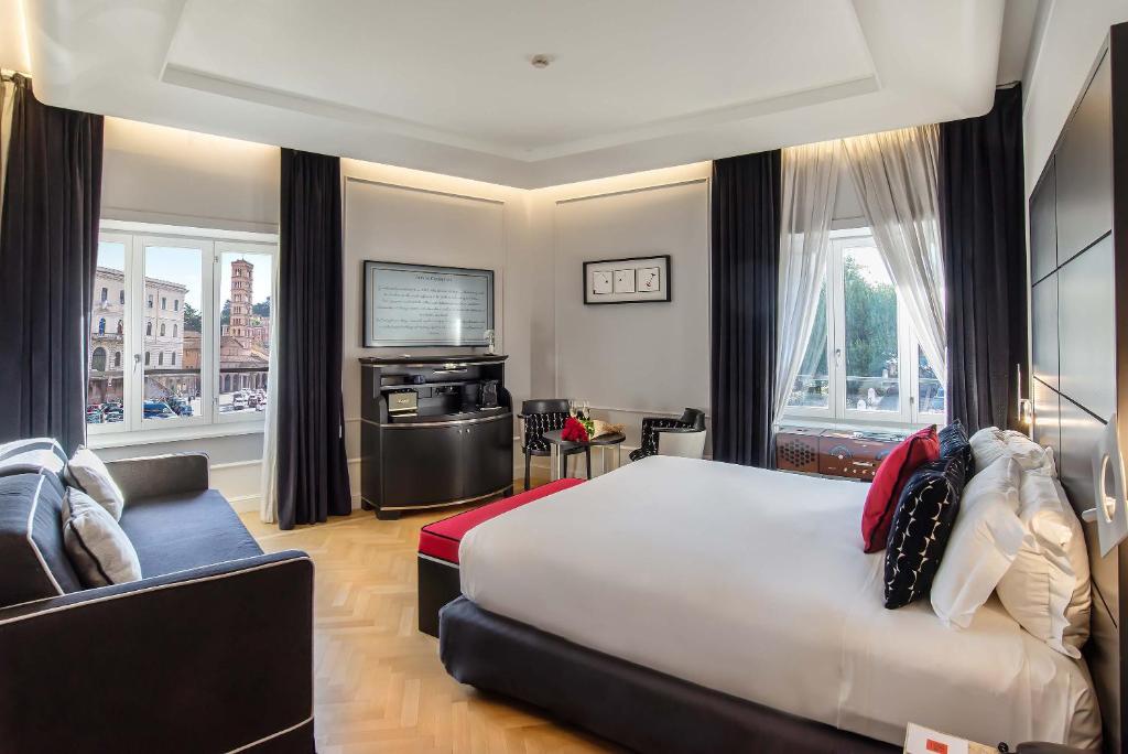 a bedroom with a large bed and a television at 47 Boutique Hotel in Rome