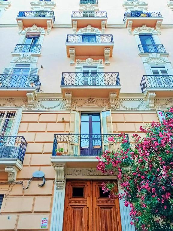 an apartment building with balconies and flowers at Le Bijou Luxury Apartment in Salerno