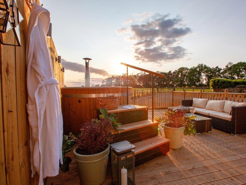 a patio with a couch and some potted plants at 2 Bed in Richmond 74305 in Barton