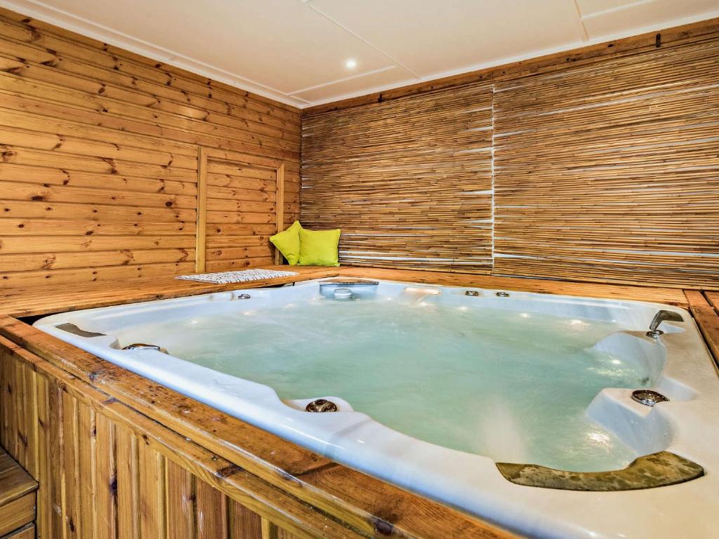 a jacuzzi tub in a room with wooden walls at 1 Bed in Shrewsbury 73521 in Ford