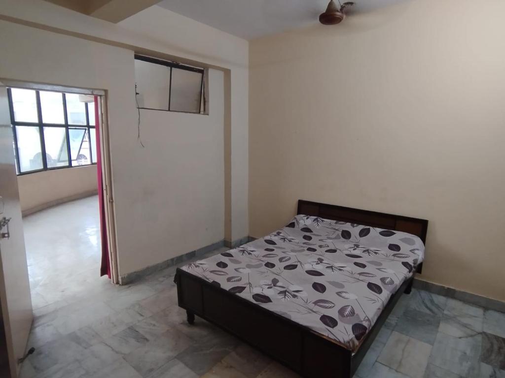 a bedroom with a bed in a room with a door at Spacious Flat - Centrally Located in Hyderabad