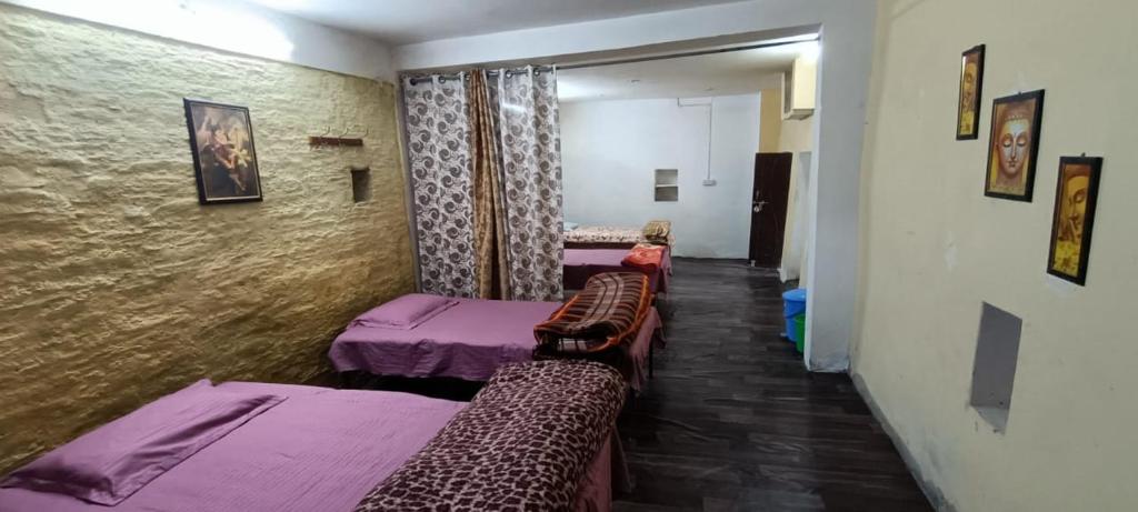 a room with two beds and a hallway at Shri Timli Mountain Village Stay in Dwārīkhāl