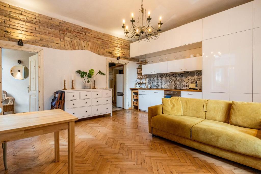 a large living room with a couch and a kitchen at Historical Wine Apartment in Bratislava