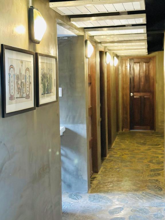 a hallway in a building with paintings on the walls at The Continental Hostel El Nido in El Nido