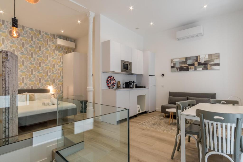 a living room with a bed and a dining room at Modern and Bright- 2 Bd 2 Bth - Center in Madrid