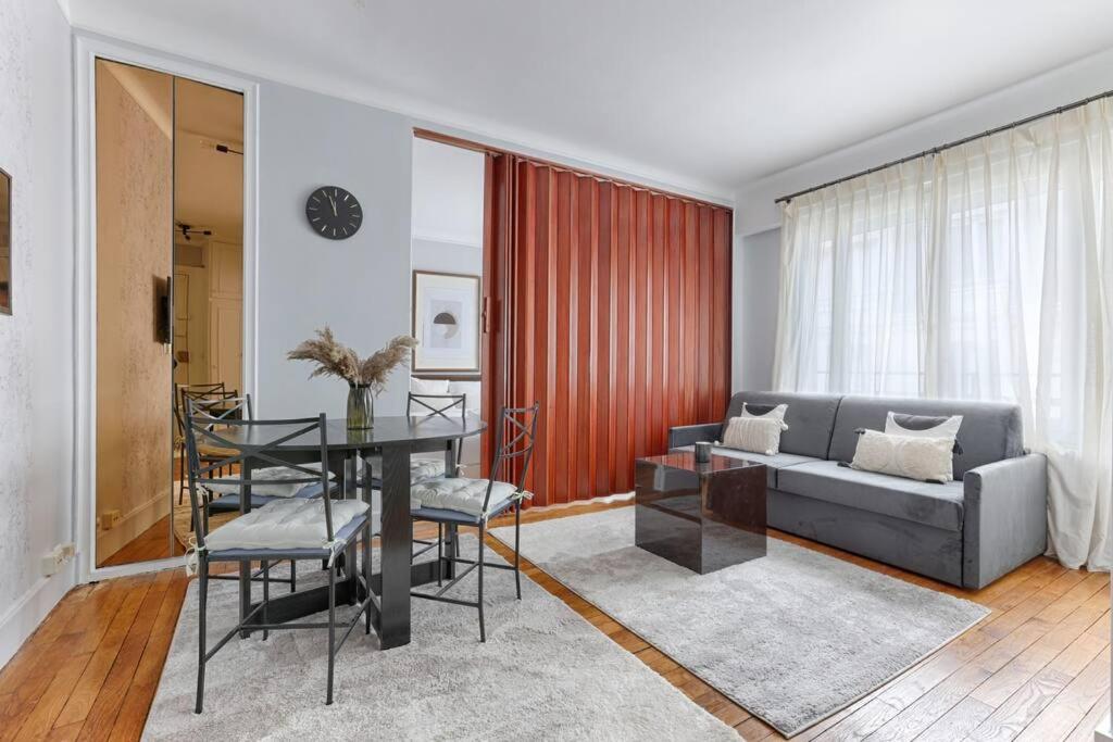 un salon avec un canapé et une table dans l'établissement Matignon Saint-Honoré : Magnifique Appartement 1BR, à Paris