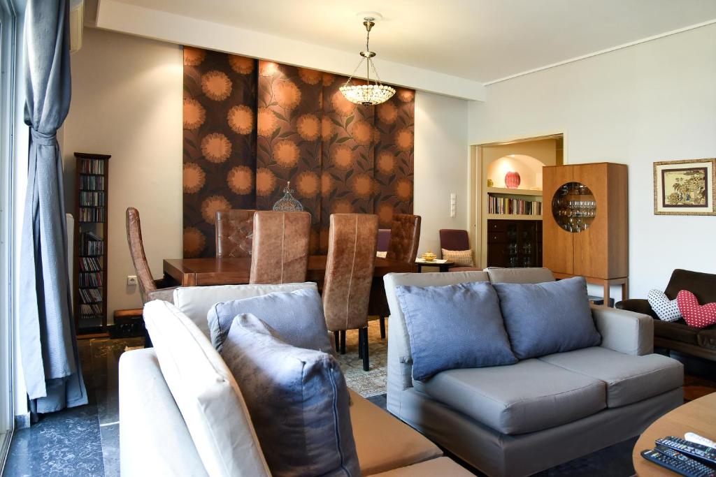 ein Wohnzimmer mit einem Sofa und einem Tisch in der Unterkunft Colourful Apt in Nea Smyrni in Athen
