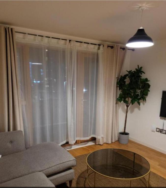 a living room with a couch and a glass table at Beautiful 1-Bed Apartment in London in London