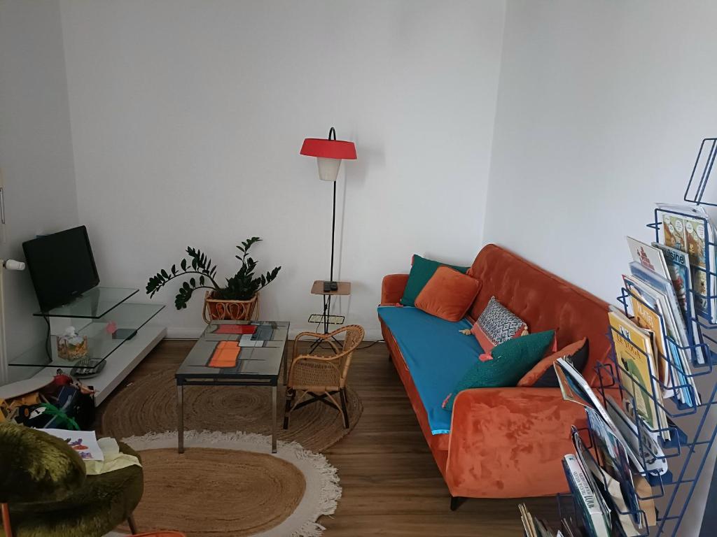 a living room with a couch and a table at maison centre ville, 15km de la mer in Challans