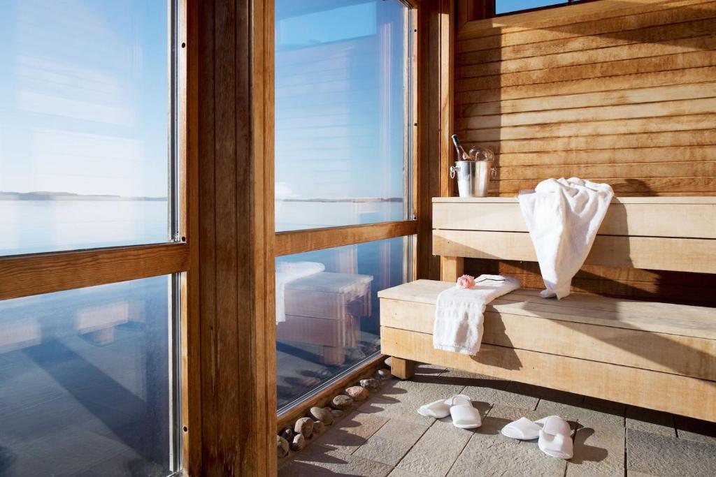 a room with a tub and a sink and a window at Strandflickornas Husen invid Havet in Lysekil