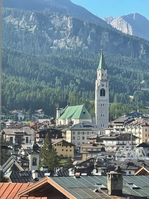 a view of a city with a clock tower at Bike and Ski dreams in Cortina dʼAmpezzo