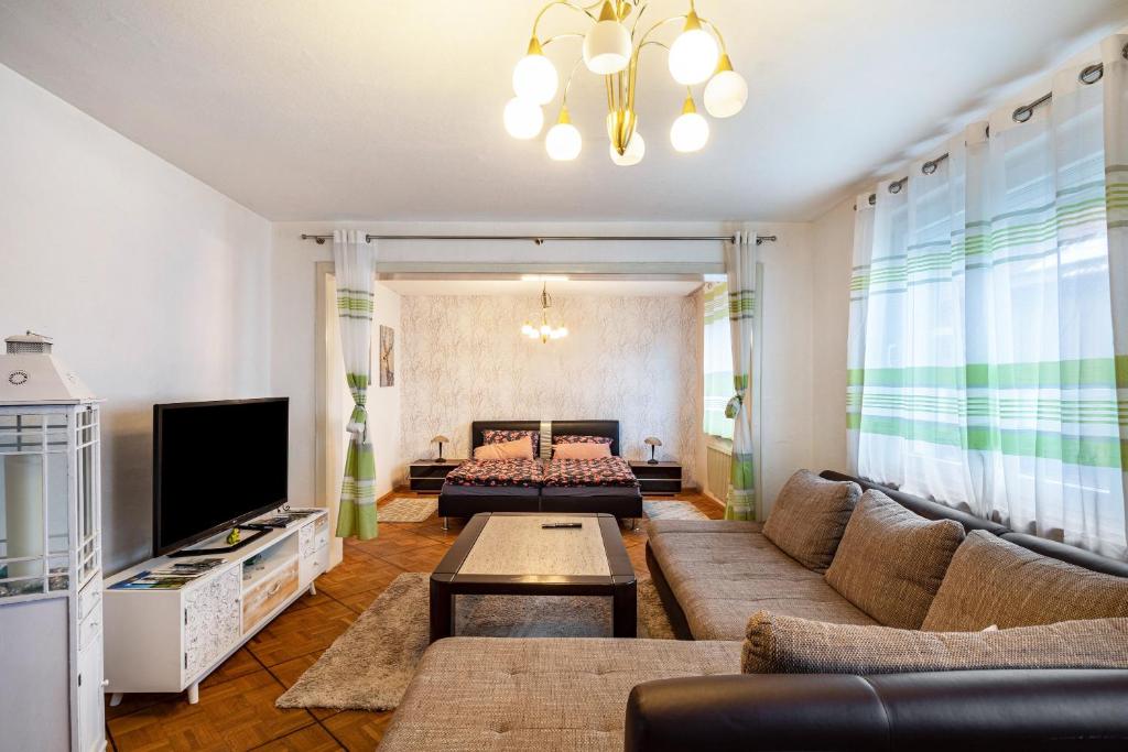 a living room with a couch and a tv at Traumschmiede in Bad Emstal