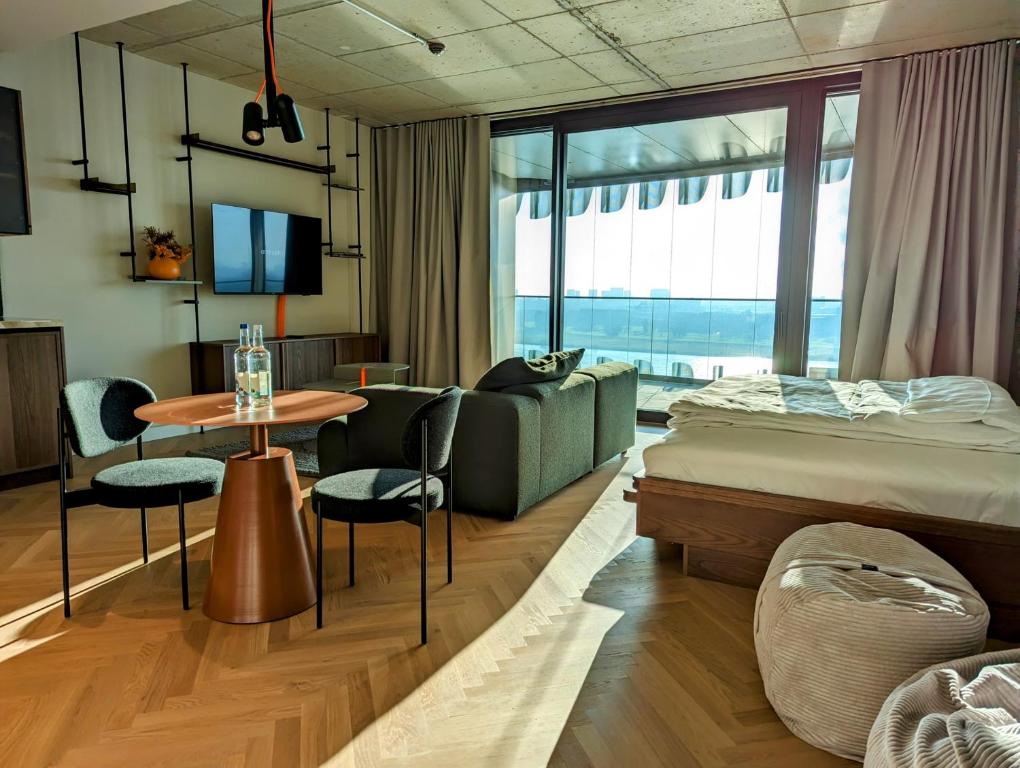 デュッセルドルフにあるThe Zipper Hotel und Apartmentsのベッドとテーブルが備わるホテルルームです。