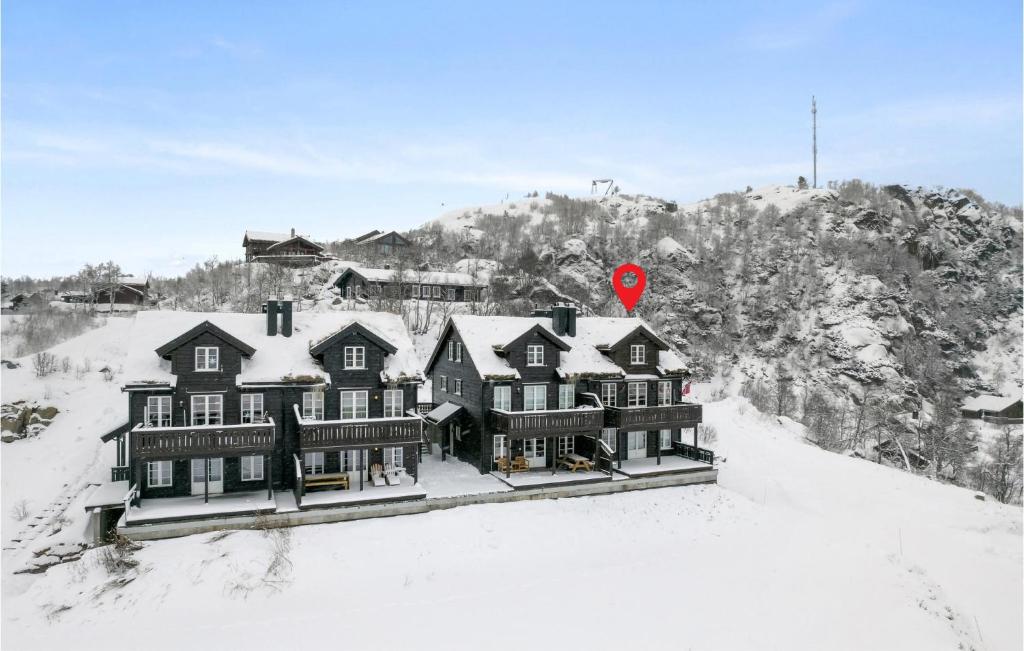 a large house in the snow with a red stop sign at Awesome Home In seral With House A Mountain View in Åseral