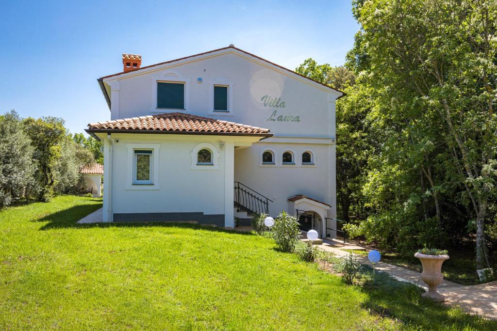 a large white house with a yard in front of it at Villa Laura in Medulin for 8 persons only 1.5 km from the beach in Medulin